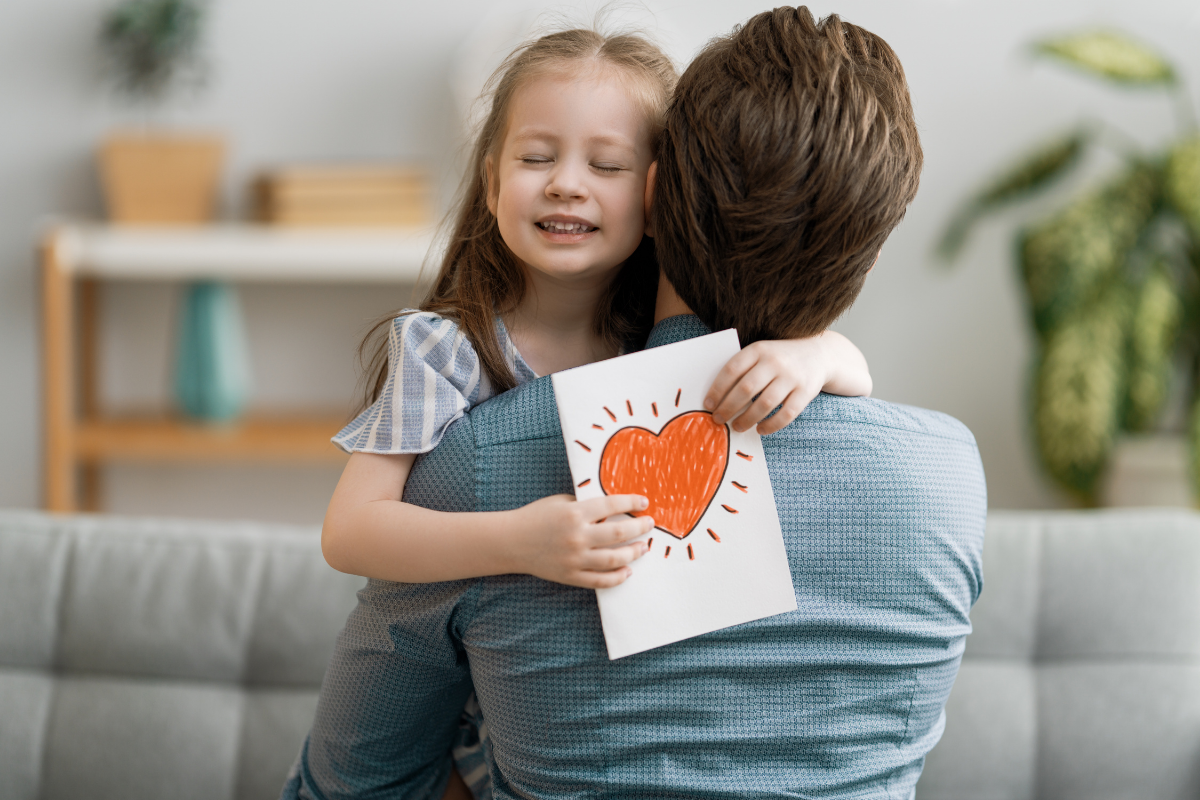 Vatertagsgeschenk 2022, Mädchen umarmt Vater
